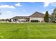 Expansive backyard featuring a pool, patio, and lush lawn perfect for outdoor enjoyment and relaxation at 1583 E Osprey Dr, Greenfield, IN 46140