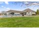 Manicured backyard features a pool, patio, outdoor seating, and landscaping around the white brick home at 1583 E Osprey Dr, Greenfield, IN 46140