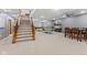 Spacious basement with ping pong table, dining set, and staircase at 1583 E Osprey Dr, Greenfield, IN 46140