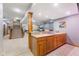 Finished basement with a staircase, a bar with wood cabinets and granite countertops, and tan carpet at 1583 E Osprey Dr, Greenfield, IN 46140