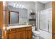 Bathroom with granite counters, wooden cabinets, and shower over tub at 1583 E Osprey Dr, Greenfield, IN 46140