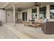 Covered patio with ceiling fans, pillar supports, outdoor seating, and a brick exterior at 1583 E Osprey Dr, Greenfield, IN 46140