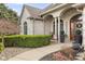 Inviting entrance with lush greenery, flowers, and charming decor, showcasing the welcoming atmosphere at 1583 E Osprey Dr, Greenfield, IN 46140