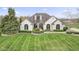 Elegant white brick home featuring arched windows and a beautifully landscaped front yard at 1583 E Osprey Dr, Greenfield, IN 46140