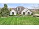 Elegant white brick home featuring arched windows and a beautifully landscaped front yard at 1583 E Osprey Dr, Greenfield, IN 46140