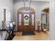 Inviting front entrance featuring an arched doorway, detailed glass, and contemporary lighting at 1583 E Osprey Dr, Greenfield, IN 46140