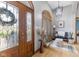 Welcoming foyer with hardwood floors, arched windows, and decorative chandelier, leading to the home's interior at 1583 E Osprey Dr, Greenfield, IN 46140