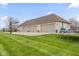Spacious three-car garage with basketball hoop, alongside a meticulously maintained lawn at 1583 E Osprey Dr, Greenfield, IN 46140