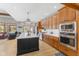 Well-lit kitchen with updated stainless steel appliances, an island with stool seating, and lots of cabinet space at 1583 E Osprey Dr, Greenfield, IN 46140