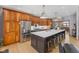 Spacious kitchen with stainless steel appliances, wooden cabinetry, and large center island with bar stool seating at 1583 E Osprey Dr, Greenfield, IN 46140