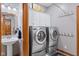 Updated laundry room with modern washer and dryer units and plenty of storage space at 1583 E Osprey Dr, Greenfield, IN 46140