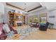 Inviting living room with a fireplace, built-in shelving, and large windows overlooking the pool at 1583 E Osprey Dr, Greenfield, IN 46140