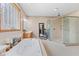 Bright bathroom with a soaking tub, a glass-enclosed shower, and modern fixtures at 1583 E Osprey Dr, Greenfield, IN 46140