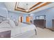 Elegant main bedroom with blue walls, a tray ceiling, and stylish furnishings at 1583 E Osprey Dr, Greenfield, IN 46140