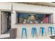 Outdoor bar with granite countertop, a stainless fridge, an American flag, and blue barstools at 1583 E Osprey Dr, Greenfield, IN 46140