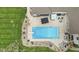 Aerial view of the pool and patio area with a hot tub and plenty of outdoor furniture at 1583 E Osprey Dr, Greenfield, IN 46140