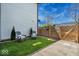Charming backyard featuring green artificial turf, a privacy fence, and outdoor seating for relaxing outdoors at 1712 Rosette Way, Indianapolis, IN 46202