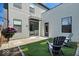 Private backyard area with artificial turf, patio, and outdoor seating; a perfect spot to relax and enjoy the outdoors at 1712 Rosette Way, Indianapolis, IN 46202
