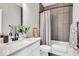 Modern bathroom with a quartz countertop vanity, tiled shower, and neutral color palette at 1712 Rosette Way, Indianapolis, IN 46202