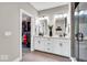 Bright bathroom with dual sinks, a walk-in closet, and a glass-enclosed shower providing ample space and luxury at 1712 Rosette Way, Indianapolis, IN 46202