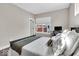Bright bedroom featuring a comfortable bed, work station, and natural light from large windows at 1712 Rosette Way, Indianapolis, IN 46202