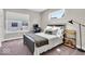 Bright bedroom featuring a comfortable bed, work station, and natural light from large windows at 1712 Rosette Way, Indianapolis, IN 46202