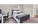 Well-lit bedroom with modern decor, a comfortable bed, and a functional desk area at 1712 Rosette Way, Indianapolis, IN 46202