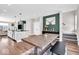 Open-concept dining area featuring hardwood floors and a large rustic wooden table at 1712 Rosette Way, Indianapolis, IN 46202