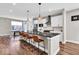 Modern kitchen with a black countertop and stainless steel appliances and seating for four at 1712 Rosette Way, Indianapolis, IN 46202