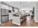 Stylish kitchen with white cabinets, stainless steel appliances, and a central island with bar seating at 1712 Rosette Way, Indianapolis, IN 46202