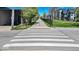 A street view with crosswalks lined with trees on a clear day near 17th St at 1712 Rosette Way, Indianapolis, IN 46202