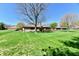 Spacious and well-maintained backyard with lush green grass, mature trees, and a brick home at 1927 Pheasant Way, Greenwood, IN 46143