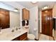 Bathroom with wood cabinets, mirror, and a shower at 1927 Pheasant Way, Greenwood, IN 46143
