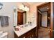 Cozy bathroom featuring a single vanity, mirror, and traditional wallpaper design at 1927 Pheasant Way, Greenwood, IN 46143