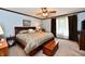 This bedroom boasts a ceiling fan, plush bedding, and soft lighting, creating a relaxing retreat at 1927 Pheasant Way, Greenwood, IN 46143