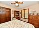 Bright bedroom with oak furnishings, a ceiling fan, and a charming quilt on the bed at 1927 Pheasant Way, Greenwood, IN 46143