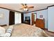 This bedroom features a ceiling fan, ample natural light, and wooden furniture accents for a warm ambiance at 1927 Pheasant Way, Greenwood, IN 46143