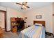 Bedroom features a built-in desk, ceiling fan, and neutral walls providing a cozy and functional space at 1927 Pheasant Way, Greenwood, IN 46143