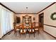 Traditional dining room boasts a wood table set with floral centerpiece and china cabinet at 1927 Pheasant Way, Greenwood, IN 46143