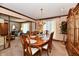 Open concept dining area connects to living room with a wooden table and seating for six at 1927 Pheasant Way, Greenwood, IN 46143