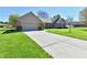 Lovely single story home with a concrete driveway, brick accents and manicured lawn at 1927 Pheasant Way, Greenwood, IN 46143