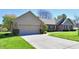 Attractive single story home with a well maintained driveway and manicured green lawn at 1927 Pheasant Way, Greenwood, IN 46143