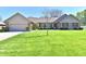 Charming brick home with manicured lawn, neat shrubbery and a welcoming two car garage at 1927 Pheasant Way, Greenwood, IN 46143