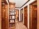 Well-lit hallway with built-in bookcase and access to bathroom, creating a functional space at 1927 Pheasant Way, Greenwood, IN 46143