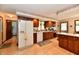 Well-lit kitchen features wood cabinets, white appliances, and a convenient breakfast bar at 1927 Pheasant Way, Greenwood, IN 46143