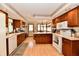 Spacious kitchen with wood cabinetry, modern appliances, and breakfast bar seating at 1927 Pheasant Way, Greenwood, IN 46143