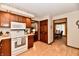 Kitchen with wood cabinets, white countertops and appliances, with access to the dining area at 1927 Pheasant Way, Greenwood, IN 46143