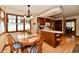 This eat-in kitchen features wood cabinets, breakfast bar, and adjoins a dining area at 1927 Pheasant Way, Greenwood, IN 46143