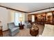 Cozy living room featuring two armchairs, a sofa, and a view into the dining room at 1927 Pheasant Way, Greenwood, IN 46143