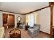 Cozy living room features wood trim, neutral carpet, and two comfortable upholstered armchairs at 1927 Pheasant Way, Greenwood, IN 46143